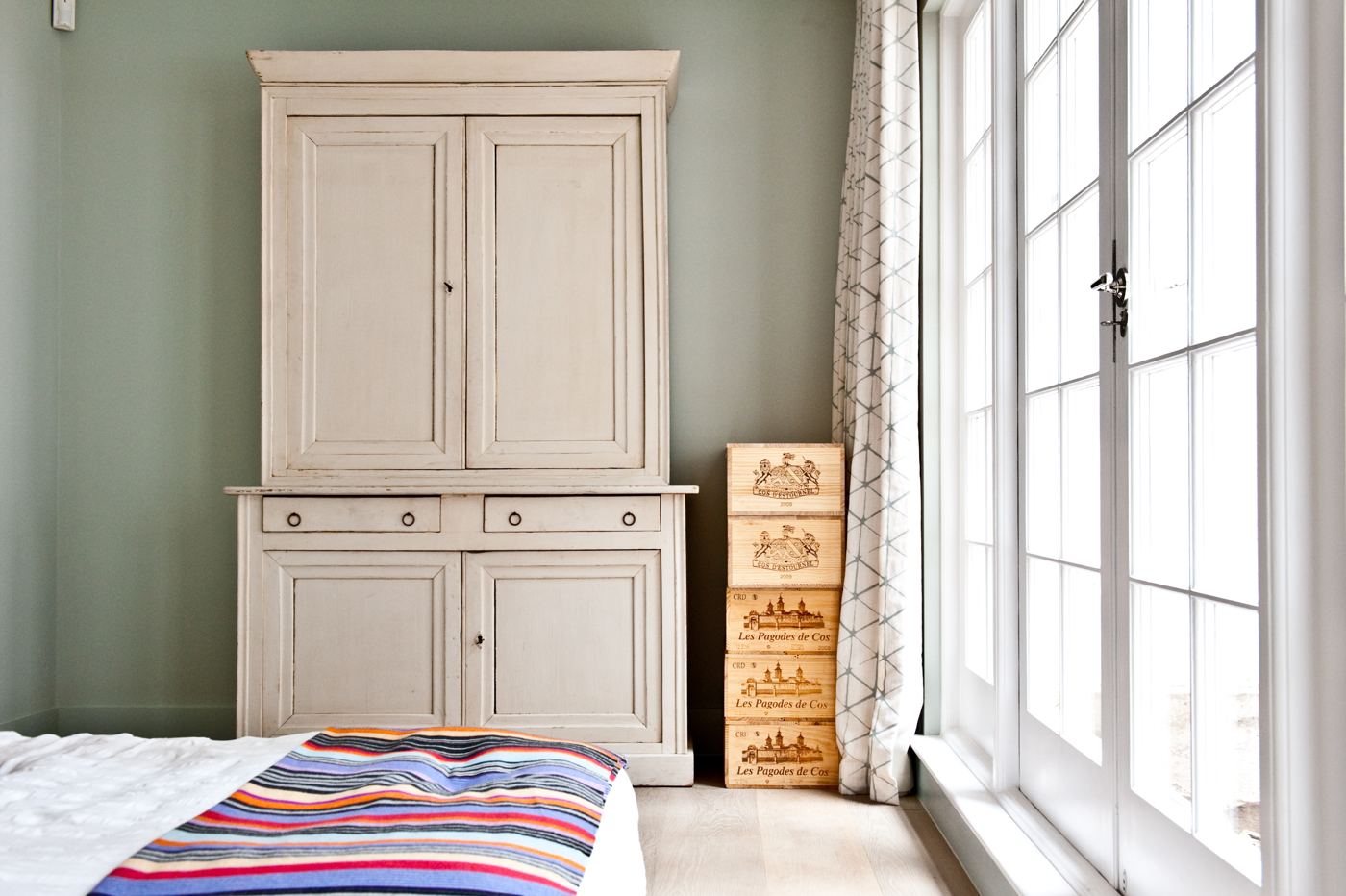 Bedroom with painted armoire and French doors