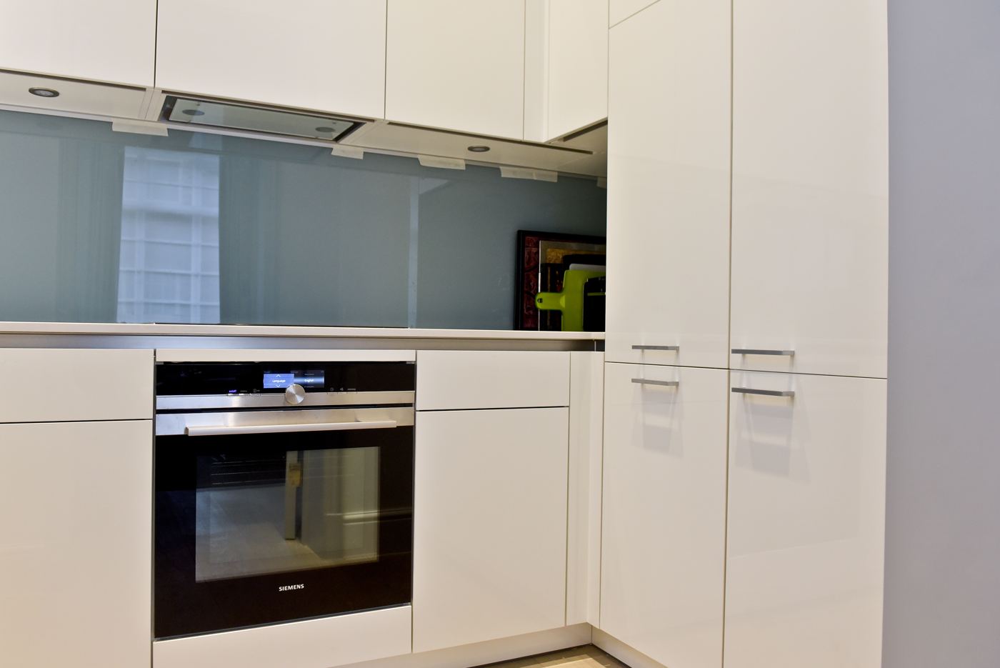 Handleless white kitchen with integrated ovens
