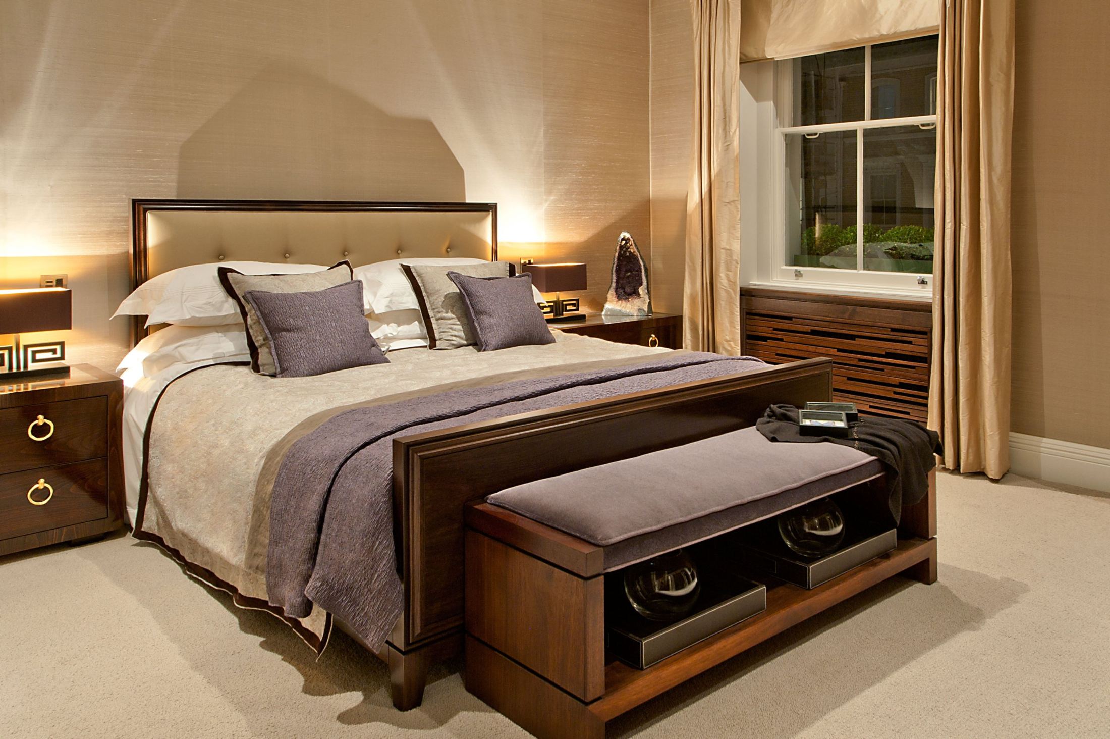Principal bedroom with upholstered headboard, walnut bed and bench, silk curtains and slatted radiator cover