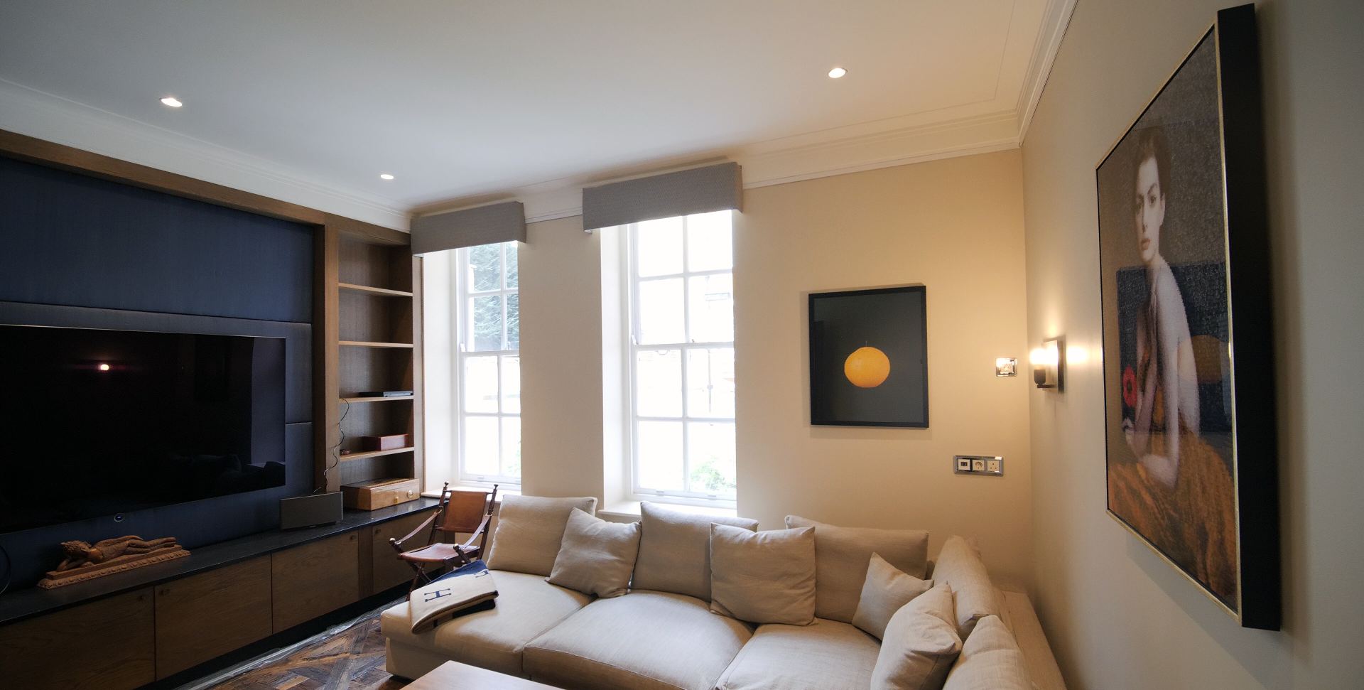 Snug with fitted oak and upholstered media wall, sash windows and pelmets